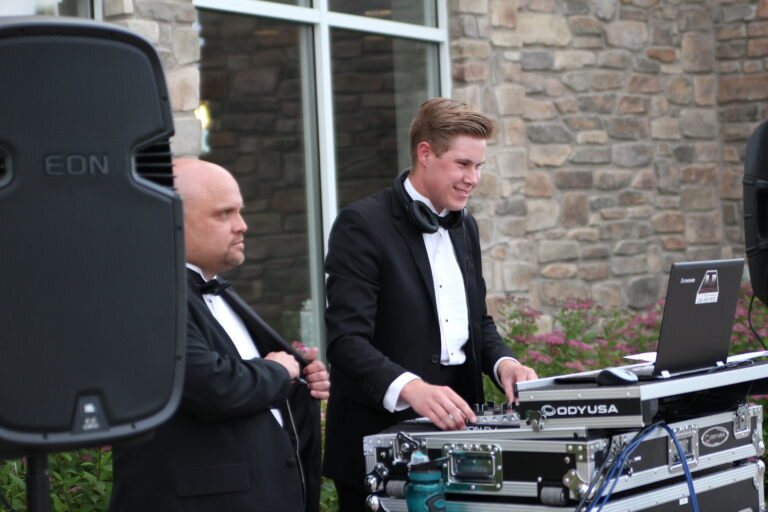 Professional DJ setup by A & B Productions with young DJ at outdoor event.