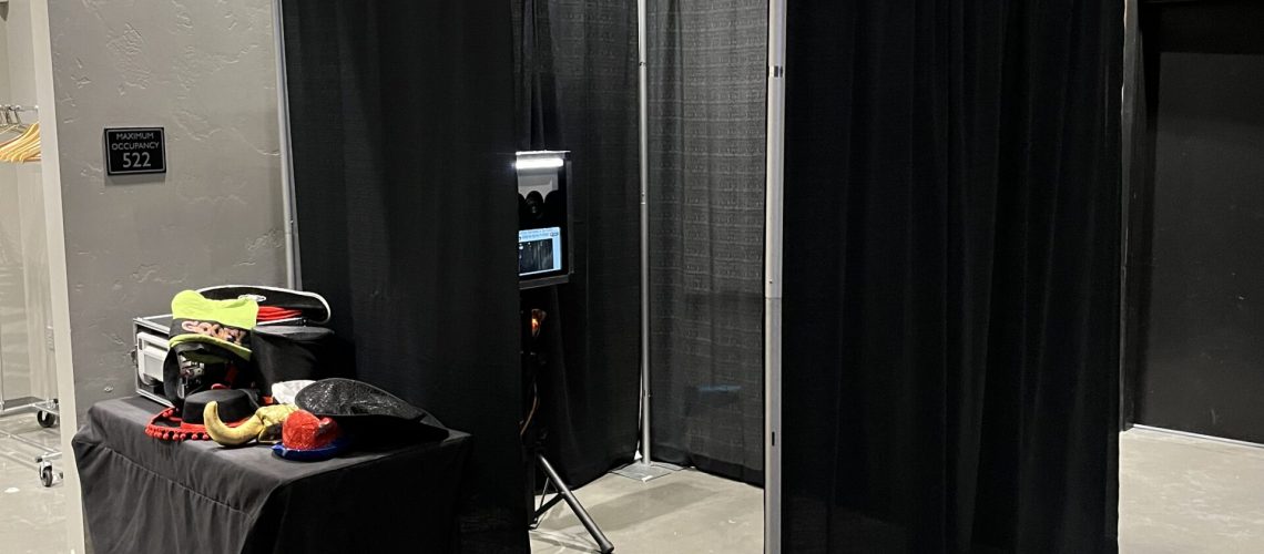 Photo booth setup with black curtains for events by A & B Productions.